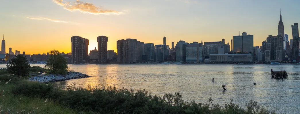 View across the east river of the midtown skyline at sunset from Hunter's Point South Park.