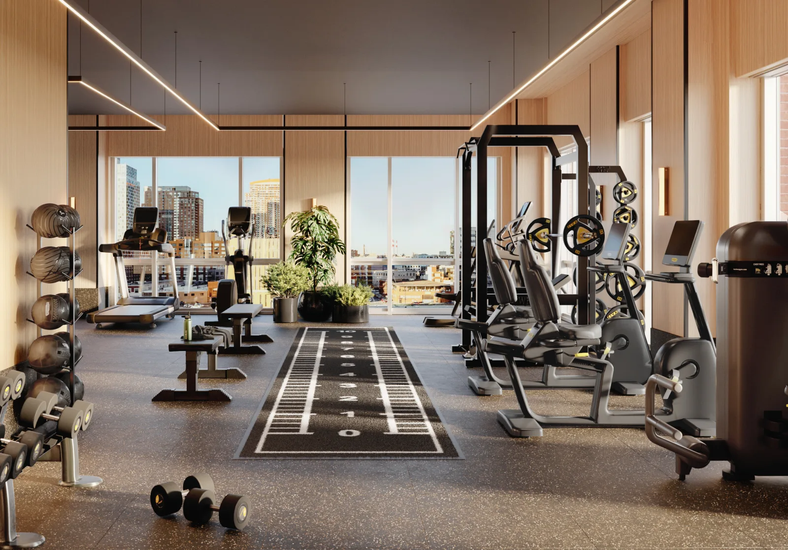 The fitness center at 2-21 Malt Dr is filled with natural light and equipment such as treadmills, spin bikes, and weights.